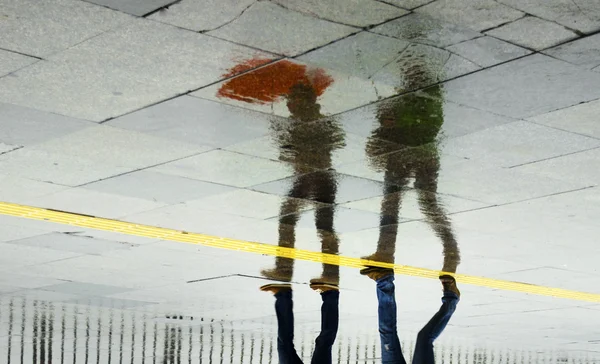 Rain reflection umbrella Two women walking in the rain — Stock Photo, Image