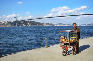 Turkish vendor sells bagels, Istanbul on the Bosphorus. clipart