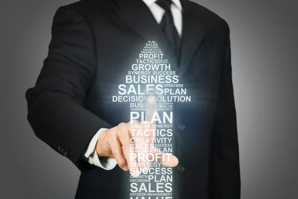 Businessman clicking on an arrow formed by business related word — Stock Photo, Image