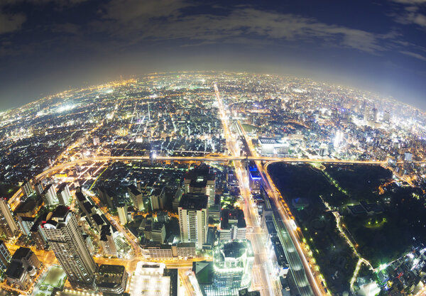 Aerial fisheye view of buildings in Osaka in Japan at night