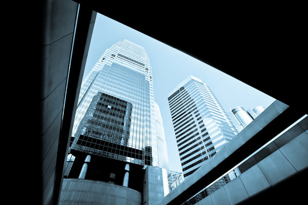 Modern buildings at financial district in Hong Kong, blue tone