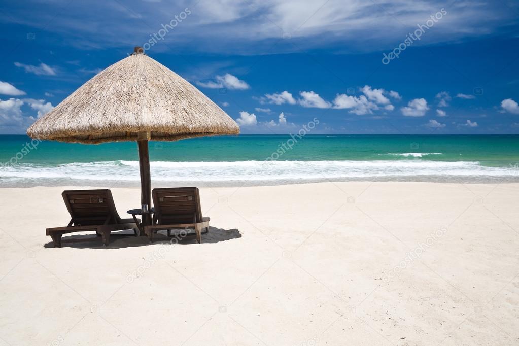 Beach umbrella and chairs with copyspace