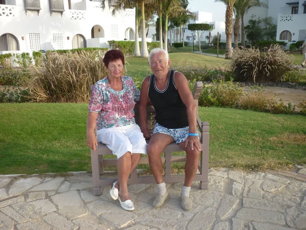 Couple of two happy elder persons together on vacation at the hotel