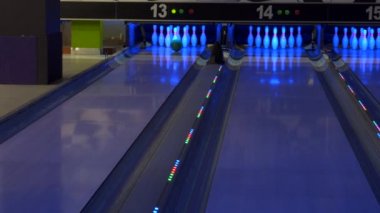 Colorful bowling alley. Bowling game. A bowling ball traveling down the lane and knocks down pins