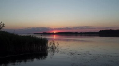 Nehrin üstünde şafak. Nehirde kayıkta bir balıkçı görebilirsiniz. Ukrayna 'daki Dinyeper Nehri