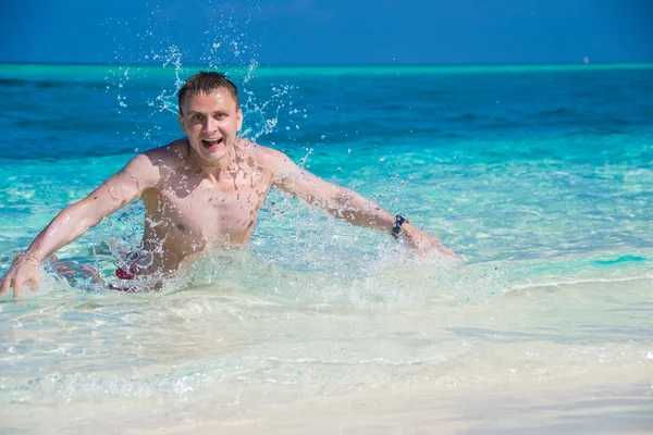 Happy man in water with water splash, — Stock Photo, Image