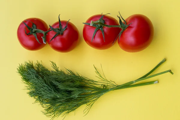 Dill and four tomatoes on yellow background, horizontal — Stock Photo, Image