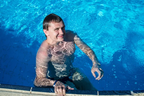 Happy man in water near swimming-pool nosing — Stock Photo, Image