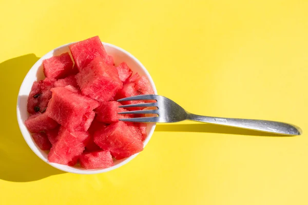 Pieces watermelon in bowl with fork — Stock Photo, Image