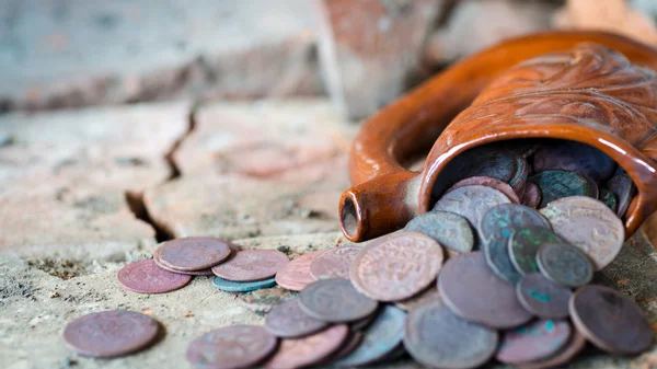 Ancient jug with coins — Stock Photo, Image