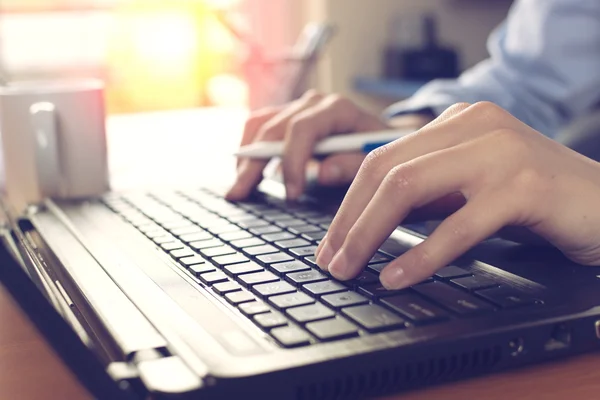 Close up of female fingers on the keyboard,back lit — Stok Foto