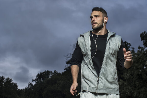 Attractive man running in park