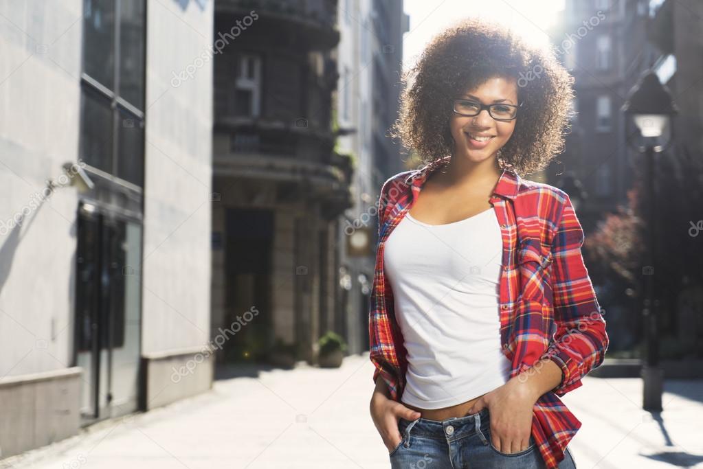 Attractive mixed race girl posing on the street
