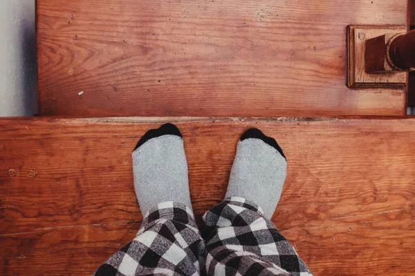 Feet in socks on the stairs.