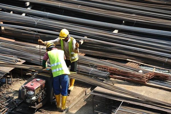 Construction workers working at the bar bending yard