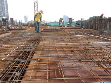 KUALA LUMPUR, MALAYSIA - 21 Kasım 2020: inşaat halindeki zemin levhası. İnşaat işçileri kereste imalatı ve çelik takviye çubuğu yapıyorlar.. 