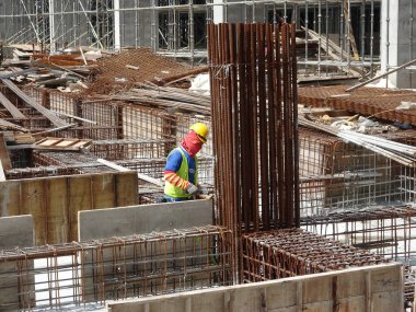 KUALA LUMPUR, MALAYSIA - 16 Temmuz 2017: Marangozlar inşaat alanında kereste ve kontrplak formları üretirler. Güçlendirilmiş beton yapının kalıbı olarak ahşap biçimlendirme.