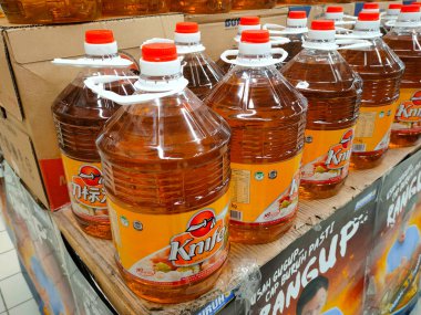 SEREMBAN, MALAYSIA -APRIL 26, 2020: Plastik kapta paketlenmiş ve süpermarkette satışa sunulan işlenmiş palmiye tohumundan yapılan pişirme yağına odaklanmış. 