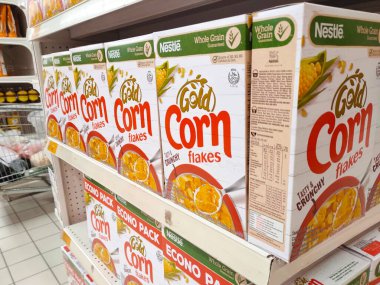 KUALA LUMPUR, MALAYSIA -MAY 20, 2020: Cereal food packed in the paper box and plastic package. Displayed on the rack in huge supermarkets. Sorted by brand. Has a price tag each.  clipart