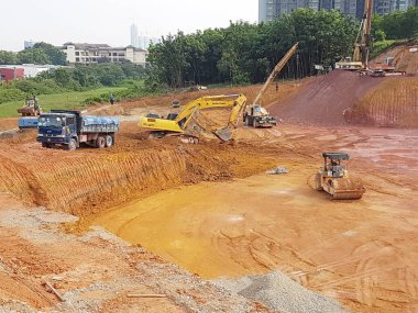 CYBERJAYA, MALAYSIA - HAZİRAN 8, 2020: Yeni gelişim alanı için toprak çalışmaları. Gerekli seviyeyi elde etmek için orman temizliği ve toprak işleri yapan ağır makineler.
