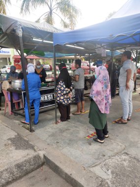 KUALA LUMPUR, MALAYSIA - 5 Mart 2020: Sokak satıcıları ve satıcıları halka yerel mal ve yiyecek satıyorlar. Yoldan geçenlere, kulübelerine uğramaları için seslendiler..