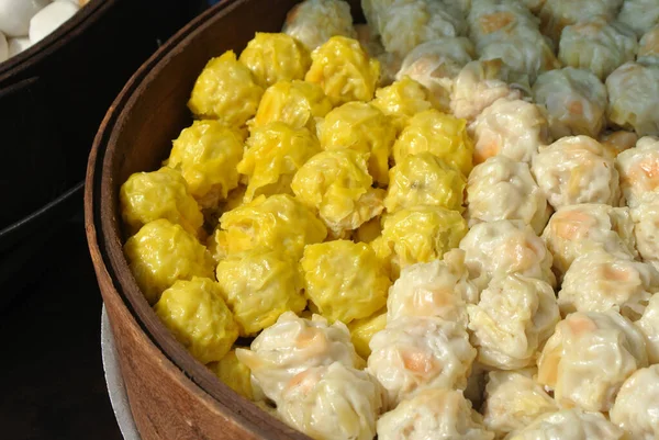 Dim Sum with miscellaneous taste in wooden steam cooker. Dim Sum is one of the famous Chinese food. It is cooked by steam at a high temperature.