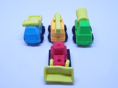 Beyaz arka planda izole edilmiş renkli sentetik kauçuktan yapılmış ağır makinenin minyatür modeli. 