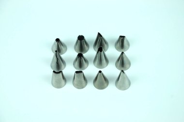 Sets of cream piping nozzles made from stainless steel isolated on white background. It is used to decorate cakes using cream.  clipart