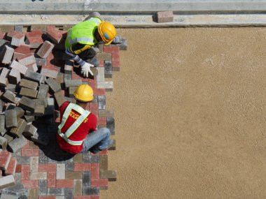 MALACCA, MALAYSIA -MAC 08, 2017: İnşaat işçileri inşaat alanında yol için beton kaldırım taşları kuruyor ve düzenliyor. 