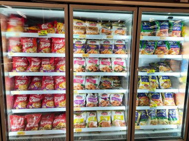 KUALA LUMPUR, MALAYSIA -APRIL 16, 2021: Dev süpermarketteki soğutucu buzdolabının içine yerleştirilmiş çeşitli markalarda ticari paketleme tavuk nuggetı üzerine odaklanmış.