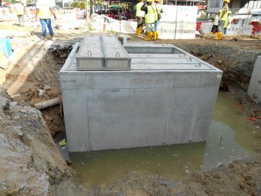 KUALA LUMPUR, MALAYSIA -JANUARY 31, 2017: Precast concrete manhole for underground utility services under construction. Normally used by electrical and telephone providers to lay their cable.  clipart