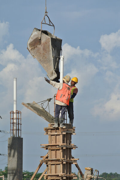 Construction workers casting column