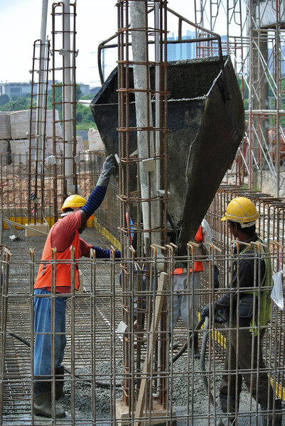 Group of construction workers casting ground floor slab