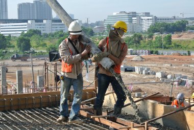 Construction Workers casting concrete using concrete hose clipart