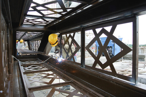 Welders welded the decorative mild steel at the construction site