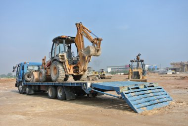 Backhoe machine on the trailer lorry