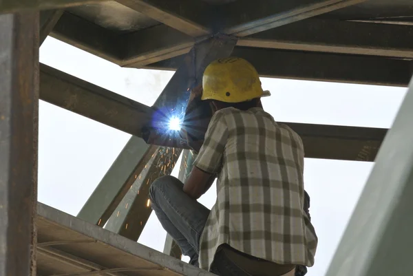 Welder with protective mask welding metal — Stock Photo, Image