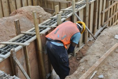 A Construction Workers Installing Ground Beam Formwork clipart