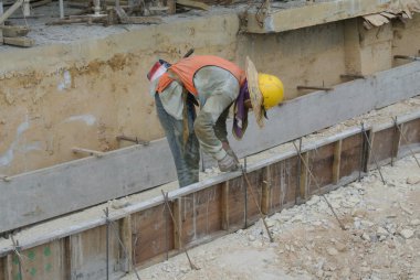 Group of workers working at ground beam formwork