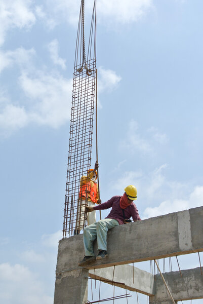 Construction workers fabricating column formwork