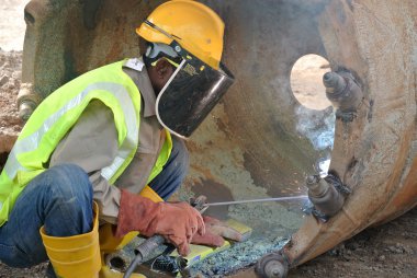 Licence welder weld bore pile auger at construction site