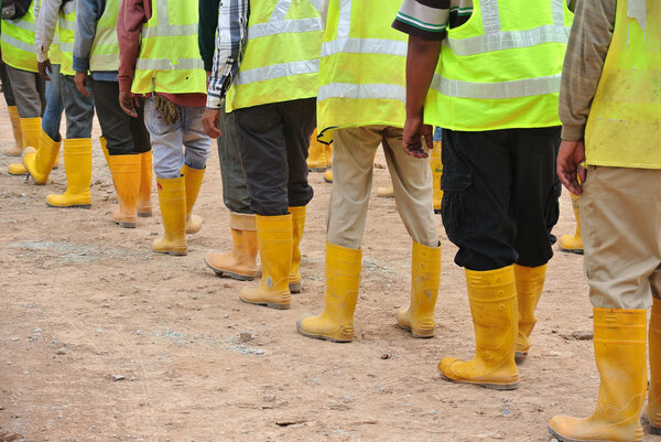 Group of construction workers assemble at the open space.