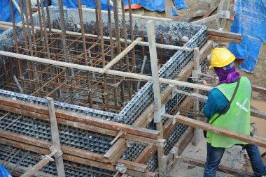 Construction workers installing pile cap formwork clipart