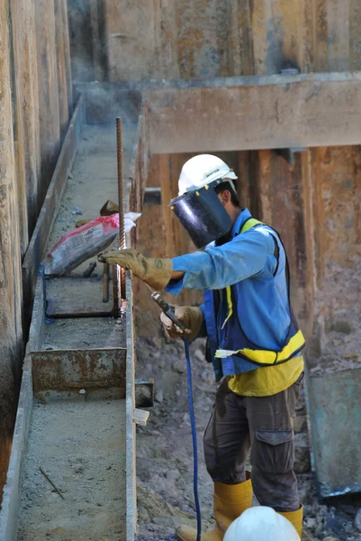 Welder strengthen the sheet pile cofferdam retaining wall