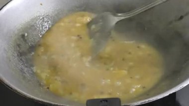 A chef is expertly preparing black pepper sauce, incorporating various ingredients into a pan. The mixture is heated and cooked, resulting in a rich and flavorful culinary creation.