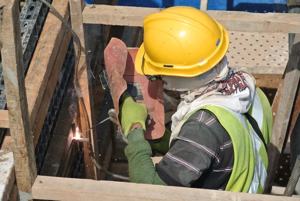 Welder with protective mask welding metal — Stock Photo, Image