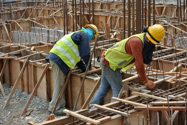 Group of construction workers fabricating ground beam steel reinforcement bar — Stock Photo, Image