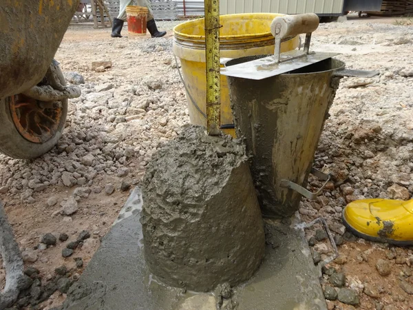 The slump test equipment. Wet concrete was compacted for the slump test.