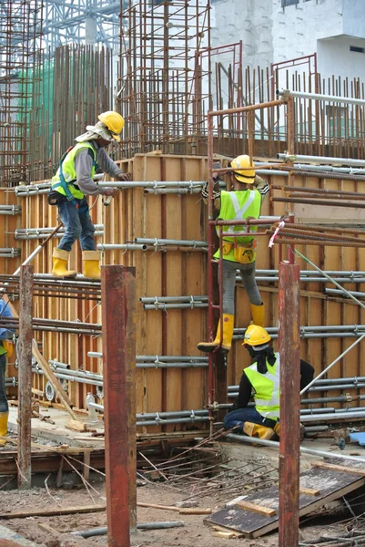 Construction workers fabricating reinforcement concrete wall form work