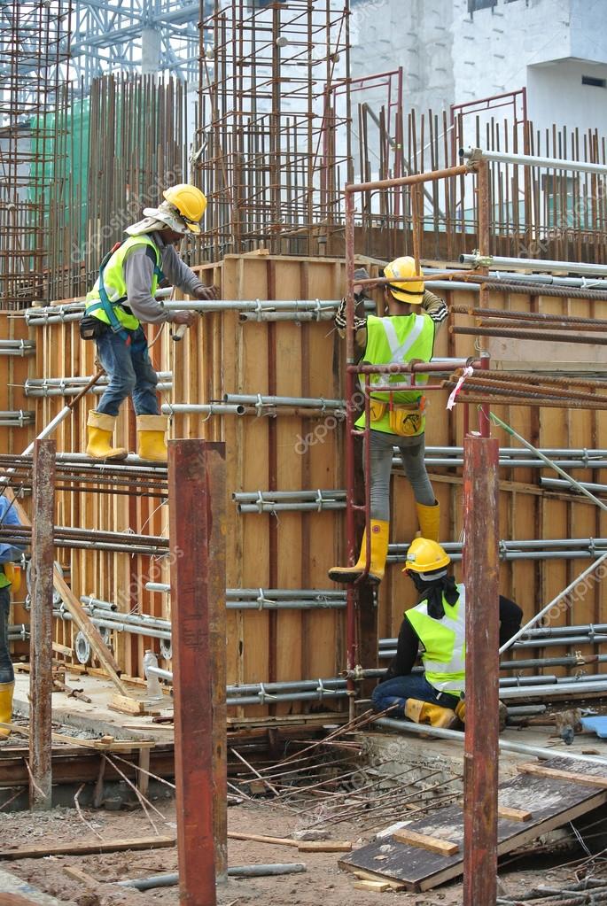 Construction workers fabricating reinforcement concrete wall form work